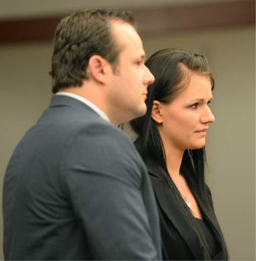 Steve Griffin / The Salt Lake Tribune

Carolyn Hughes stands with her attorney Steve Burton as she listens to Judge Katie Bernards-Goodman during her preliminary hearing at the Matheson Courthouse in Salt Lake City Thursday June 23, 2016.  Hughes is charged with a Class A misdemeanor count of negligent homicide for failing to restrain her 3-year-old daughter in a car.