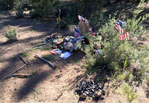 In this June 21, 2016, photo, a memorial to LaVoy Finicum marks the spot where Finicum, one of the armed occupiers of the Malheur National Wildlife Refuge, was killed in January by police at a roadblock near Burns, Ore. Winter and spring have passed since an armed occupation of a federal wildlife refuge ended in Oregon, but aftershocks of the takeover are still hitting this high desert region.  (AP Photo/Andrew Selsky)