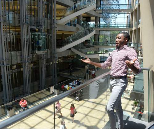 Al Hartmann  |  The Salt Lake Tribune 
Markel Reed, a baritone with Utah Opera, sings his finale from a high balcony in a "pop-up" performance in the atrium of City Library Thursday June 23, the first afternoon of the Utah Arts Festival.  
"Random acts" of art, like this performance happen away from the traditional stages at the Utah Arts Festival.  Library.