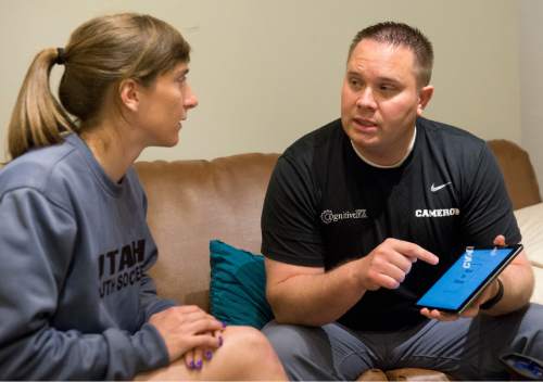 Rick Egan  |  The Salt Lake Tribune

University of Utah soccer assistant coach Molly Poletto (left) gets instructions from MRI technician, Cameron Willardson, at cognitiveFX in Provo, Thursday, May 26, 2016.