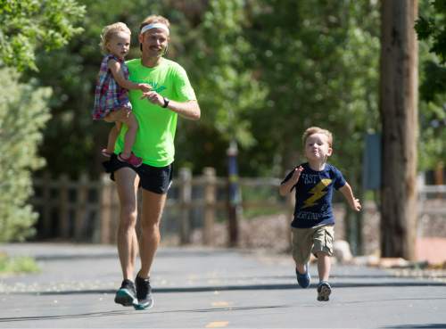 Rick Egan  |  The Salt Lake Tribune

Former BYU distance runner Jared Ward, holds his 2-year-old Ellie, as he races his 4-year-old son Paul, on the Rail Trail in Park City, Tuesday, June 21, 2016.