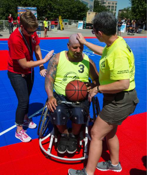 Steve Griffin / The Salt Lake Tribune

Dannie Greenlee and Kim Genung, who are both registered nurses at the VA Hospital in Salt Lake City, slather wheelchair athlete Jeff DeLeon with sun screen before an exhibition wheelchair basketball game at Vivint SmartHome Arena in Salt Lake City kicking off the 36th National Veterans Wheelchair Games are in Salt Lake City Monday June 27, 2016. This year over 625 athletes from all over the world will converge in Salt Lake City for the games June 27- July 2.