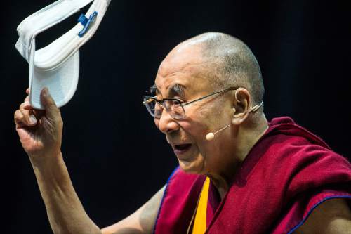 The Dalai Lama waves goodbye to the crowd after speaking at the Huntsman Center at the University of Utah in Salt Lake City, Tuesday, June 21, 2016. (Chris Detrick/The Salt Lake Tribune via AP) MANDATORY CREDIT