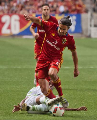 Michael Mangum  |  Special to the Tribune

Seattle Sounders defender Joevin Jones slide tackles the ball away from Real Salt Lake defender Tony Beltran during their U.S. Open Cup match at Rio Tinto Stadium in Sandy, UT on Tuesday, June 28th, 2016. The match ended in a 1-1 draw with Seattle advancing after winning in a penalty kick shootout.