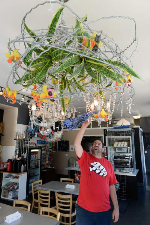 Francisco Kjolseth | The Salt Lake Tribune
Straw Market co-owner Tayler McDonald shows off the wild chandeliers that grace his eatery in the Avenues. Fresh pastries are baked daily and retail for $1, including the popular cinnamon roll, which is not available until 7:15 a.m. For large orders, McDonald says order in advance or you will be out of luck.