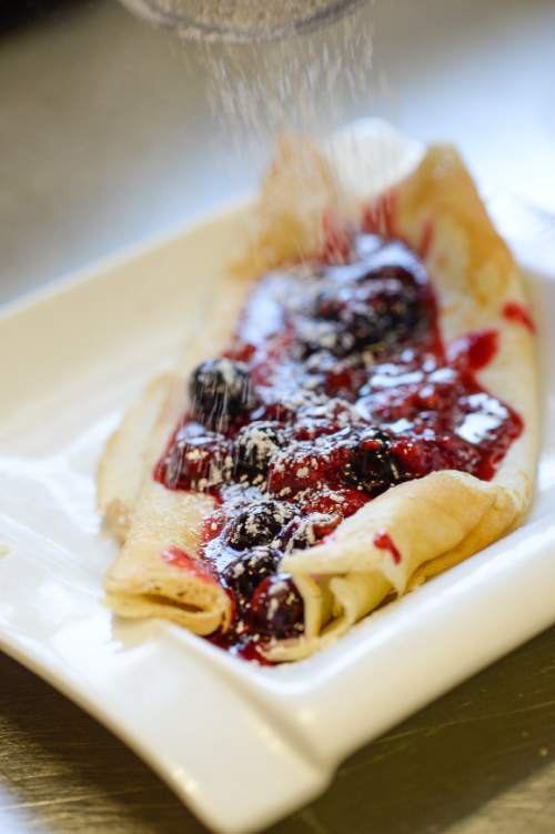 Francisco Kjolseth | The Salt Lake Tribune
A mixed berry crepe gets frosted with sugar at Straw Market in the Avenues.