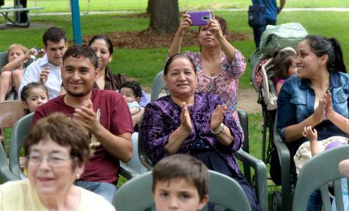 Al Hartmann  |  The Salt Lake Tribune 
Friends and relatives applaud as sixteen people raise their hands to be sworn in as new U.S. citizens in a naturalization ceremony Friday July 1 at the Freedom Festival in Scera Park in Orem.  They are from Austrailia, Brazil, Canada, Ecuador, El Salvador, Honduras, Mexico, South Africa, India and the United Kingdom.
