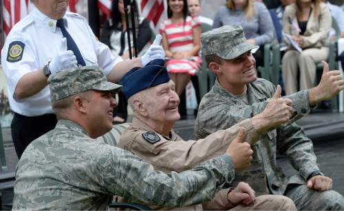 Al Hartmann  |  The Salt Lake Tribune 
Retired Air Force Col. Gail Halvorsen (known as WW2's Berlin air lift candy bomber) gives a thumbs up sign with modern day soldiers at the Freedom Festival in Orem Friday July 1 where 16 people were sworn in as new U.S. citizens.