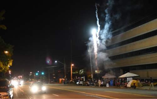 Francisco Kjolseth | The Salt Lake Tribune
Revelers light off fireworks along the Pioneer Day parade route on Thursday night, July 23, 2015.