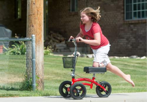 Rick Egan  |  The Salt Lake Tribune
Lydia Petrucka, 10, rides her knee scooter near her home in Springville. She will be attending the Amputee Coalition Paddy Rossbach Youth Camp in Clarksville, Ohio next week.