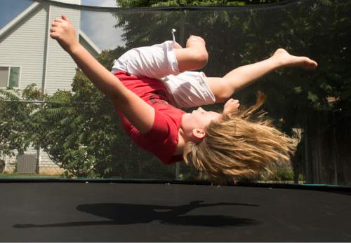 Rick Egan  |  The Salt Lake Tribune

Lydia Petrucka, 10, jumps on the trampoline in her back yard. She will be attending the Amputee Coalition Paddy Rossbach Youth Camp in Clarksville, Ohio next week. Despite the loss of her left leg, she spending time with her dogs and jumping on her trampoline. Saturday, July 2, 2016.