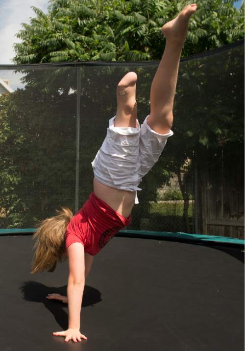 Rick Egan  |  The Salt Lake Tribune

Lydia Petrucka, 10, jumps on the trampoline in her back yard. She will be attending the Amputee Coalition Paddy Rossbach Youth Camp in Clarksville, Ohio next week. Despite the loss of her left leg, she spending time with her dogs and jumping on her trampoline. Saturday, July 2, 2016.
