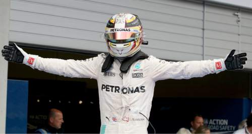 Mercedes driver Lewis Hamilton of Britain reacts after winning the Formula One Grand Prix, at the Red Bull Ring  racetrack in Spielberg, southern Austria, Sunday, July 3, 2016.  Lewis Hamilton pushed past Mercedes teammate Nico Rosberg on the final lap to win the Austrian Grand Prix on Sunday. Max Verstappen in a Red Bull was second and Kimi Raikkonen of Ferrari was third.  (AP Photo/Ronald Zak)