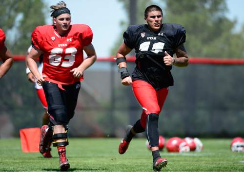 Scott Sommerdorf   |  The Salt Lake Tribune
Utah DE Kylie Fitts, right, takes part in wind sprints at the end of Utah football practice, Saturday, August 15, 2015. At left is OL Griffin Kemp.