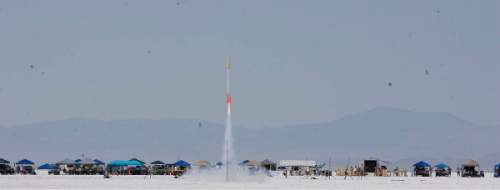 Paul Fraughton | Salt Lake Tribune
TThe rocket of Jim and Tobin Yehle blasts off at the Utah Rocket Club's Hellfire 2012, an annual rocket launch  held on the Bonneville Salt Flats near Wendover.
 Friday, August 3, 2012