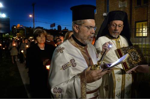 Scott Sommerdorf   |  The Salt Lake Tribune
Rev. Matthew Gilbert, left, chants during the Lamentation of the Tomb procession in April 2015 at Holy Trinity Greek Orthodox Cathedral as Father Luke Kontgis holds a flashlight. Members of the Greek Orthodox Church of Greater Salt Lake's Holy Trinity Cathedral and Prophet Elias Church are mourning a diagnosis of late-stage bone cancer for their senior priest, Rev. Gilbert.