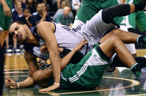 Steve Griffin / The Salt Lake Tribune

Utah Jazz forward Trey Lyles grimaces as he lands on Boston's Malcolm Miller during the Jazz versus Celtics summer league game at the Vivint Smart Home Arena in Salt Lake City Tuesday July 5, 2016. Lyles was called for an offensive foul on the play.