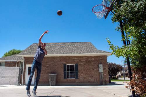 Chris Detrick  |  The Salt Lake Tribune
Alan Hamson,  7-foot-3, plays basketball at his home in Lindon Tuesday May 31, 2016.