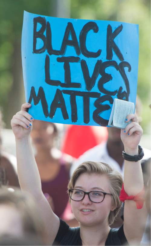 Rick Egan  |  The Salt Lake Tribune

Izzy Fawson holds a sign at the protest against police brutality to support the protests in Baton Rouge and St. Paul, at the Salt Lake City Public Safety Building, Saturday, July 9, 2016.