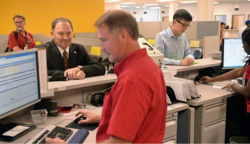 Al Hartmann  |  The Salt Lake Tribune 
Utah Gov. Gary Herbert receives his temporary driver license at the Fairpark Driver License office in Salt Lake City on Monday, July 11.  He has to wait 4-6 weeks to receive his permanent card.  He is one of the first to obtain the new, more secure card the state is now issuing.