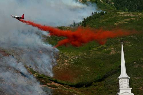 Chris Detrick  |  The Salt Lake Tribune

Crews work to put out the Quail fire above Alpine Tuesday July 3, 2012. A wildfire that started about 2 p.m. Tuesday in Lambert Park in Alpine has burned at least one structure -- a barn -- and 80 homes have been evacuated, according to the Lone Peak Police Department. Utah County Sheriff's Sgt. Spencer Cannon said the fire was human-caused -- somehow sparked by a man was working on a trackhoe near the Alpine rodeo grounds.