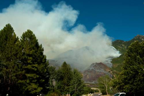 Chris Detrick  |  The Salt Lake Tribune

The Quail fire burns above Alpine Tuesday July 3, 2012. A wildfire that started about 2 p.m. Tuesday in Lambert Park in Alpine has burned at least one structure -- a barn -- and 80 homes have been evacuated, according to the Lone Peak Police Department. Utah County Sheriff's Sgt. Spencer Cannon said the fire was human-caused -- somehow sparked by a man was working on a trackhoe near the Alpine rodeo grounds.