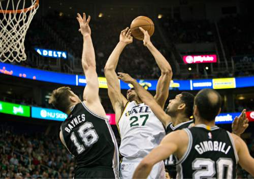 Lennie Mahler  |  The Salt Lake Tribune

Rudy Gobert draws a foul from Spurs forward Tim Duncan as Aron Baynes helps on defense in the first half of a game at EnergySolutions Arena in Salt Lake City on Monday, Feb. 23, 2015.