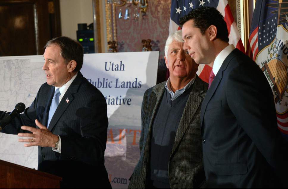 Al Hartmann  |  The Salt Lake Tribune
Utah Governor Gary Herbert, left, speaks in support at unveiling of a "discussion draft" of a Public Lands Initiative bill affecting 18 million acres in seven eastern Utah counties at the  Capitol Tuesday Jan. 20 as bill sponsor Congressman Rob Bishop and Congressman Jason Chaffetz talk at right.  Bishop intends on introducing the bill in congress in the next few weeks.