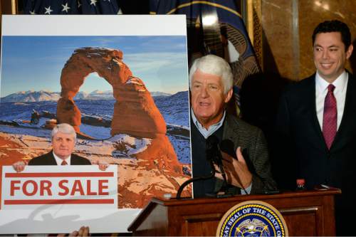 Al Hartmann  |  The Salt Lake Tribune
Utah Congressman Rob Bishop shows a poster criticising his views of federal land use as Congressman Jason Chaffetz chuckles.  Bishop said that it was an old photo of him 60 lbs. heavier and that a new photo should be used. The three then unveield a "discussion draft" of their Public Lands Initiative bill affecting 18 million acres in seven eastern Utah counties at the  Capitol Tuesday Jan 20.  Bishop intends on introducing the bill in congress in the next few weeks.