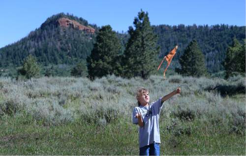 Scott Sommerdorf   |  The Salt Lake Tribune  
Dineh native 9-year old Donald West Jr. plays with a kite with one of the Bears Ears in the background as a meeting with native people and U.S. Interior Secretary Sally Jewell proceeds in a meadow atop the Bears Ears, Friday, July 15, 2016.
