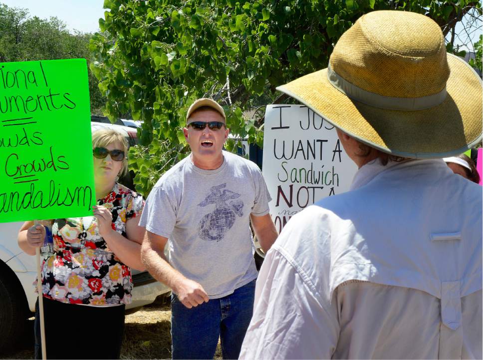 Scott Sommerdorf   |  The Salt Lake Tribune  
George Rice of San Juan County, yells at Peter Gatch, right, who came from Park City to support the Bears Ears National Park idea with a sign outside the Bluff Community Center, Saturday, July 16, 2016. Rice mentioned that if Gatch likes the National Park he "should go make one in Park City, and leave the people down here alone."