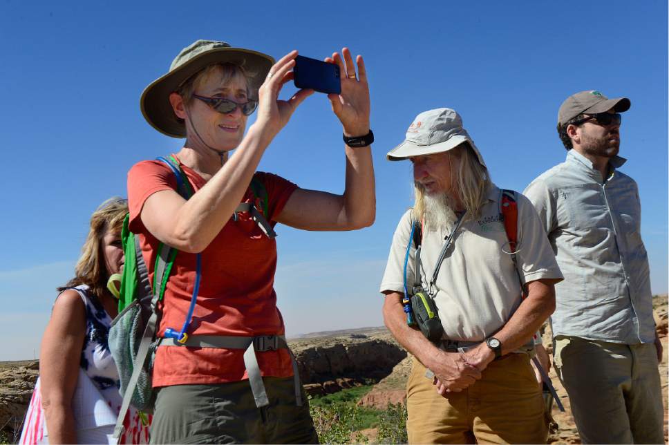 Scott Sommerdorf   |  The Salt Lake Tribune  
U.S. Interior Secretary Sally Jewell makes a photo on top of the peak overlooking Comb Ridge. Second from the right is Vaughn Hadenfeldt of Friends of Cedar Mesa, and at right is BLM Director Neil Kornze, Saturday, July 16, 2016.