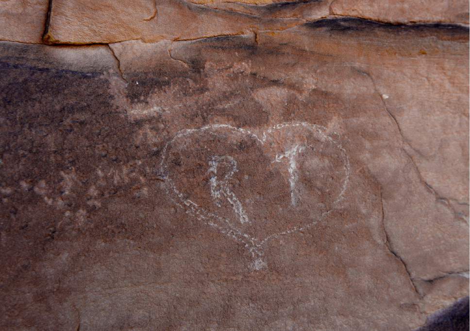 Scott Sommerdorf   |  The Salt Lake Tribune  
An ancient petroglyph of a figure was vandalized recently when someone scratched "R T" in a heart over the art dating back to around 600 AD in Butler Wash near the Comb Ridge, Saturday, July 16, 2016.