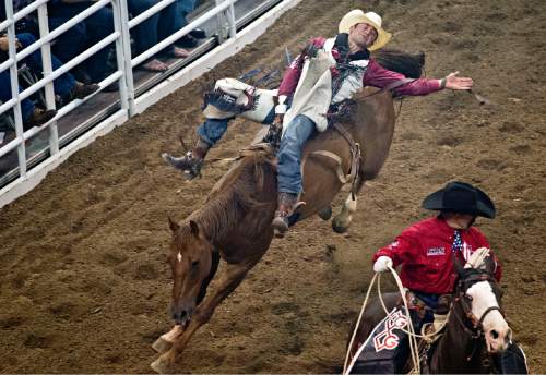 Lennie Mahler  |  The Salt Lake Tribune

Kaycee Feild, of Spanish Fork, scores a 71 in the bareback bronc riding event in the Days of '47 Rodeo at EnergySolutions Arena, Saturday, July 25, 2015.