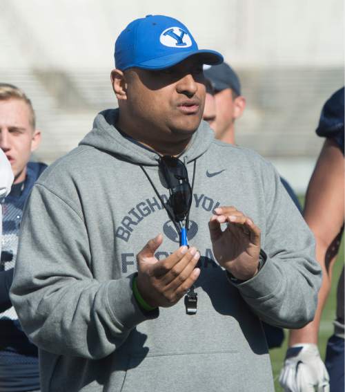Rick Egan  |  The Salt Lake Tribune

BYU head football coach Kalani Sitake  sings the Cougar fight song, after BYU's final practice of spring camp, at LaVell Edwards Stadium, Friday, April 1, 2016.