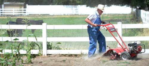Steve Griffin / The Salt Lake Tribune

Larry Brown tills some ground at his Taylorsville, Utah home Monday July 18, 2016. Brown built his home in Taylorsville 40 years ago and has been irrigating his fields and pasture land with canal water ever since. Today was the first day he hasn't been able to use the canal water because the canal has been shut down due to concerns that the water is contaminated by algae.