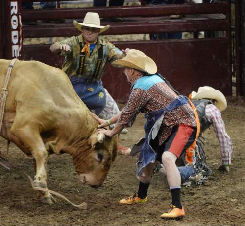 Steve Griffin  |  The Salt Lake Tribune


Rodeo clowns get in between a bull and a fallen rider during the Days of 47 Rodeo in EnergySolutions Arena in Salt Lake City, Tuesday, July 21, 2015.