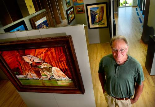 Scott Sommerdorf   |  The Salt Lake Tribune  
Artist Ron Larson poses, Thursday, July 7, 2016, alongside his new "Vistas and Visions of the Colorado Plateau" show opening at the George S. & Dolores Dore Eccles Art Gallery at SLCC.