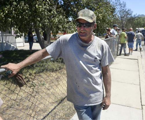 Al Hartmann  |  The Salt Lake Tribune 
Tooele resident Jeff Fuell describes how the fire from burning homes across the street whipped over his house and singed his trees late Tuesday night.  His house was barely spared.  He ran across the street and pounded on neighbors' doors to warn them of the fire that was upon them. Officials suspect  arson that destroyed 10 homes and damaged others in in the 600 West 600 South area of Tooele before finally being controlled early Wednesday morning July 20, 2016..