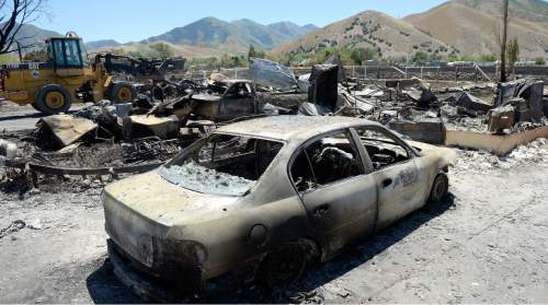 Al Hartmann  |  The Salt Lake Tribune 
Officials suspect arson destroyed 10 homes and other property in a neighborhood in Tooele, Utah, on Wednesday, July 20, 2016.