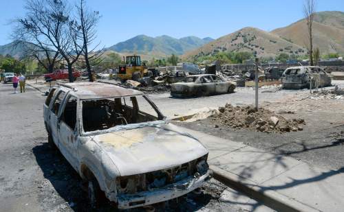 Al Hartmann  |  The Salt Lake Tribune 
Officials suspect arson destroyed 10 homes and other property in a neighborhood in Tooele, Utah, on Wednesday, July 20, 2016.