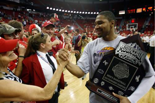 Rick Egan  |  The Salt Lake Tribune

With trophy in hand, Utah guard Lawrence Borha (11) shakes hands with Utah fans, after Utah defeated San Diego State in the Mountain West Championship game, at the Thomas & Mack Center in Las Vegas, Nevada, Saturday, March 14,  2009.