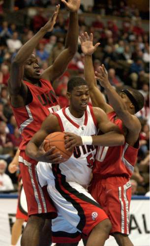 Steve Griffin  |  The Salt Lake Tribune

Utah's Justin Hawkins gets trapped by UNLV's Louis Amundson (left) and Jerel Blassingame during second half action in the Utah UNLV men's basketball game at the Pepsi Center in Denver March 11., 2005.