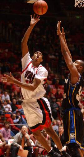 Rick Egan  |  The Salt Lake Tribune

Richard Chaney takes the ball to the hoop against Coppin State's Henrey Colter at the Huntsman center on December 20, 2004.