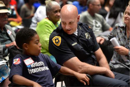 Scott Sommerdorf   |  The Salt Lake Tribune  
SLC Police Chief Mike Brown speaks with a young man during a break in a public engagement workshop called  "Transforming Together," at the Sorenson Unity Center, Thursday, July 21, 2016.