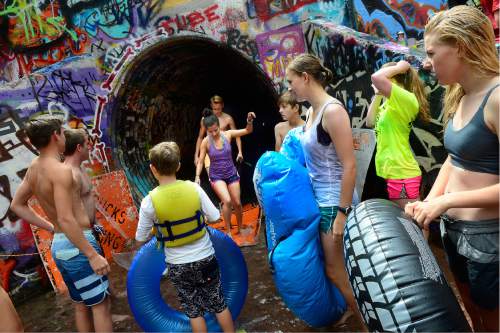 Scott Sommerdorf   |  The Salt Lake Tribune  
Tubers in foreground wait their turn to "shoot the tube" as others return to the starting point after walking back up the tube, near Tanner Park, Friday, July 22, 2016.
