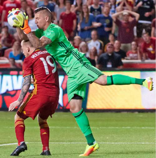 Michael Mangum  |  Special to the Tribune

San Jose goalkeeper David Bingham (1) grabs the ball out of the air over Real Salt Lake midfielder Luke Mulholland (19) during their MLS match at Rio Tinto Stadium in Sandy, Utah on Friday, July 22nd, 2016.