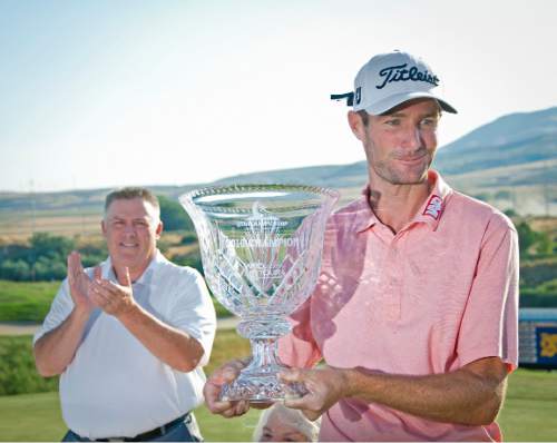 Michael Mangum  |  Special to the Tribune

Tournament winner Nicholas Lindheim hoists the Utah Championship trophy with Bobby Casper over his right shoulder after winning the Web.com Tour's tournament at Thanksgiving Point in Lehi, Utah on Sunday, July 24th, 2016. Lindheim won with a final score of -15.