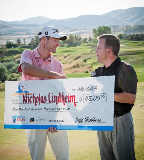 Michael Mangum  |  Special to the Tribune

Tournament winner Nicholas Lindheim shakes hands with and accepts the winners check from Rob Brough at the Web.com Tour's Utah Championship tournament at Thanksgiving Point in Lehi, Utah on Sunday, July 24th, 2016. Lindheim won with a final score of -15.