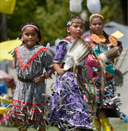 Al Hartmann  |  The Salt Lake Tribune 
Teen "Jingle" dancers compete at the annual Native American Celebration at Liberty Park July 25.   Jingle Dresses are decorated with rolled up snuff can lids hung with ribbon.  Ribbons are sewn to the dress and placed close enough so they can hit together making a beautiful sound.